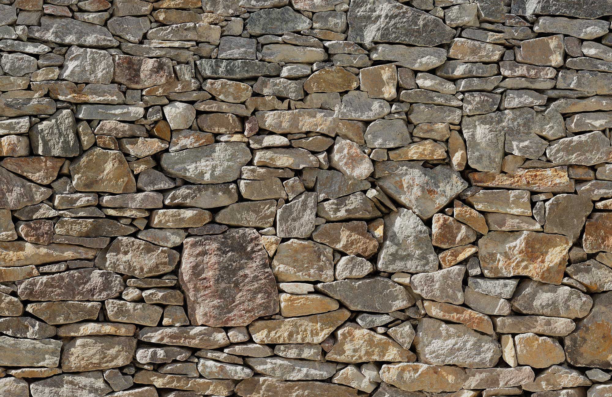 Image of Komar Fototapete »Stone Wall«, Motiv, Deutsches Qualitätsvlies (155 g/m²). Formstabil, strapazierfähig, geruchsfrei, glatt und umweltfreundlich. FSC®-zertifiziertes Produkt. Bahnbreite 50 cm. bei Ackermann Versand Schweiz