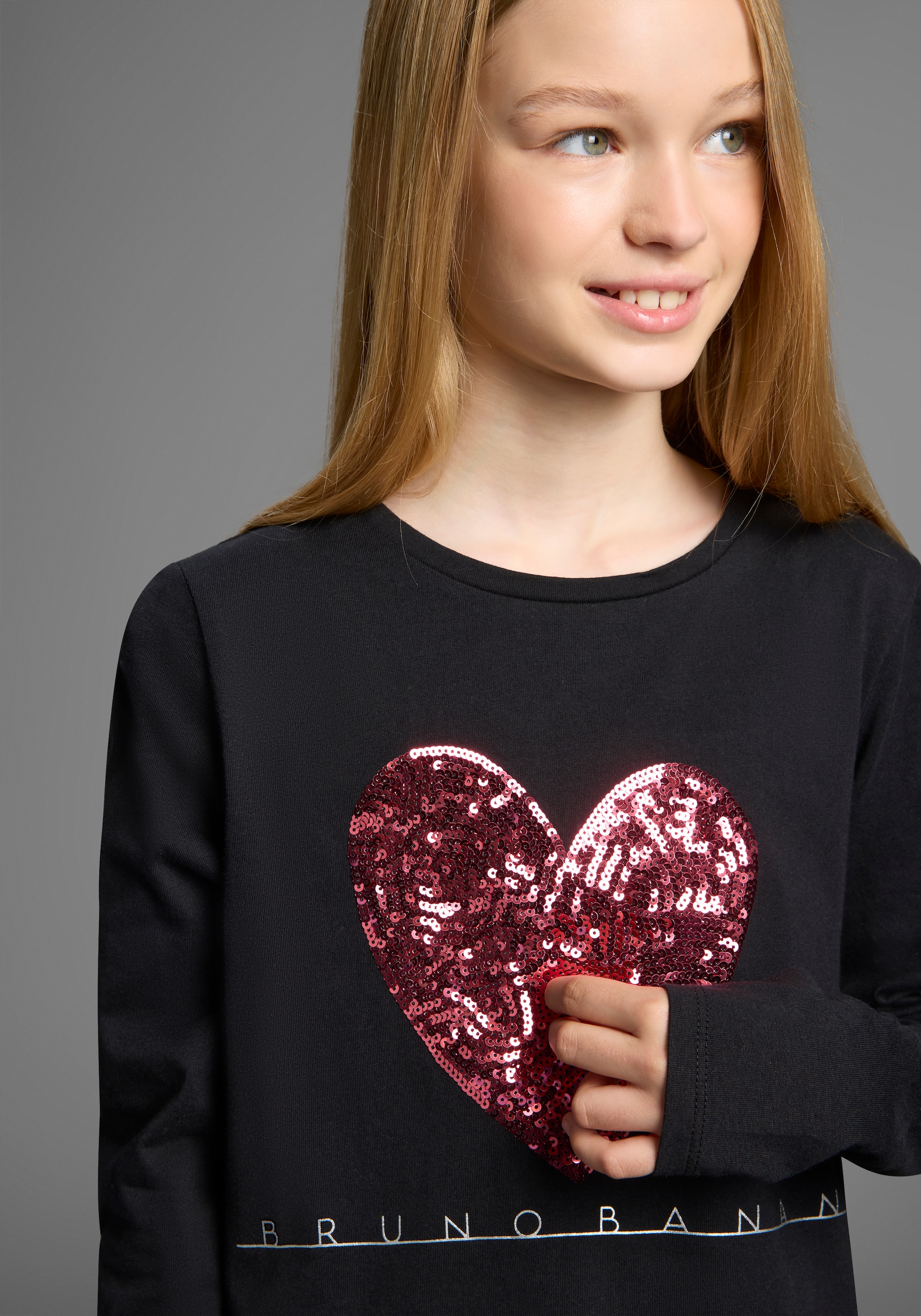 Image of Bruno Banani Langarmshirt "WENDE-Pailletten - Glitzerherz" Für TEENS. Cooles Paillettenshirt