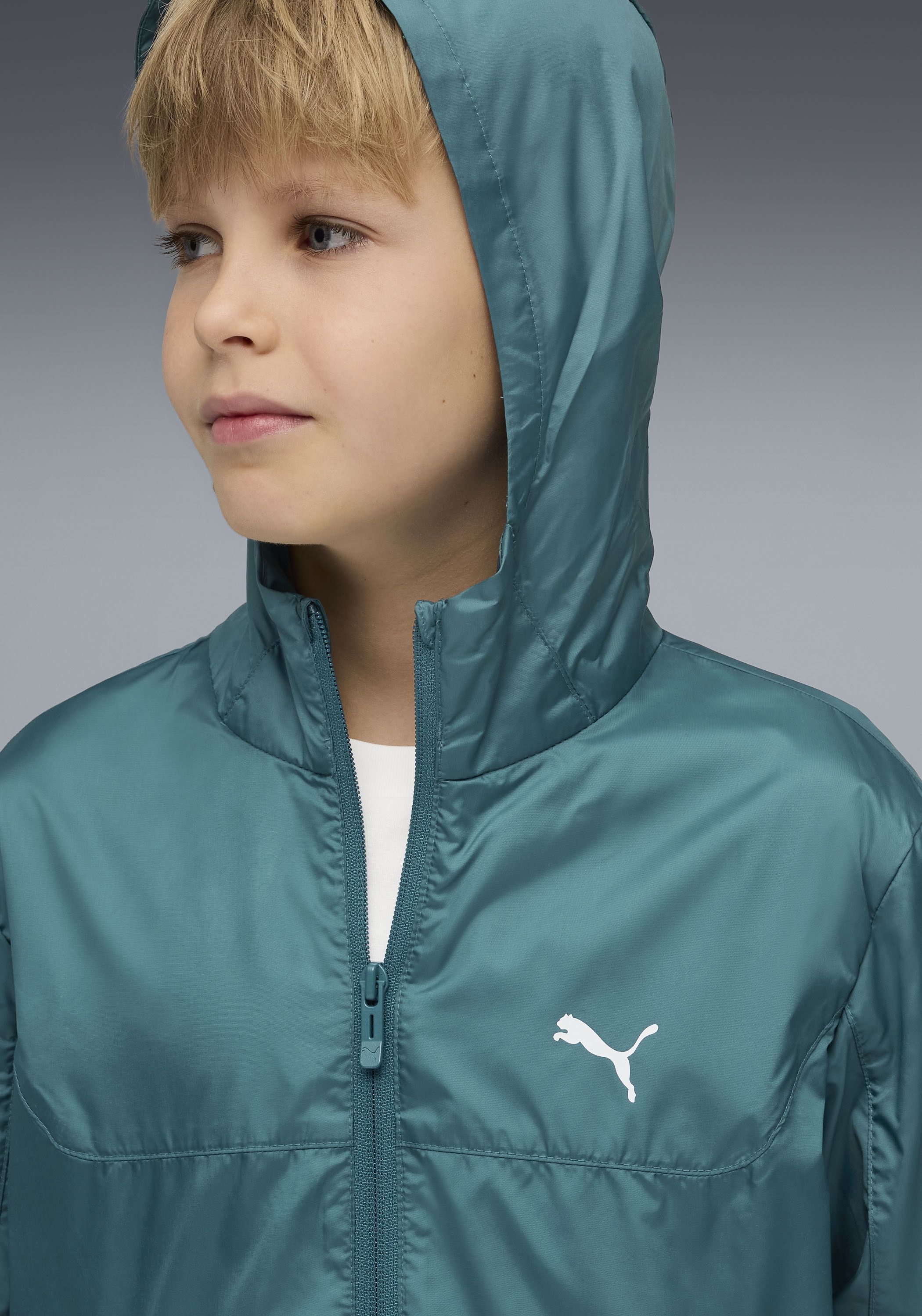 PUMA Windbreaker »ESS REGULAR WINDBREAKER« mit Kapuze für Jugendliche, mit Kapuze, mit Eingrifftasche